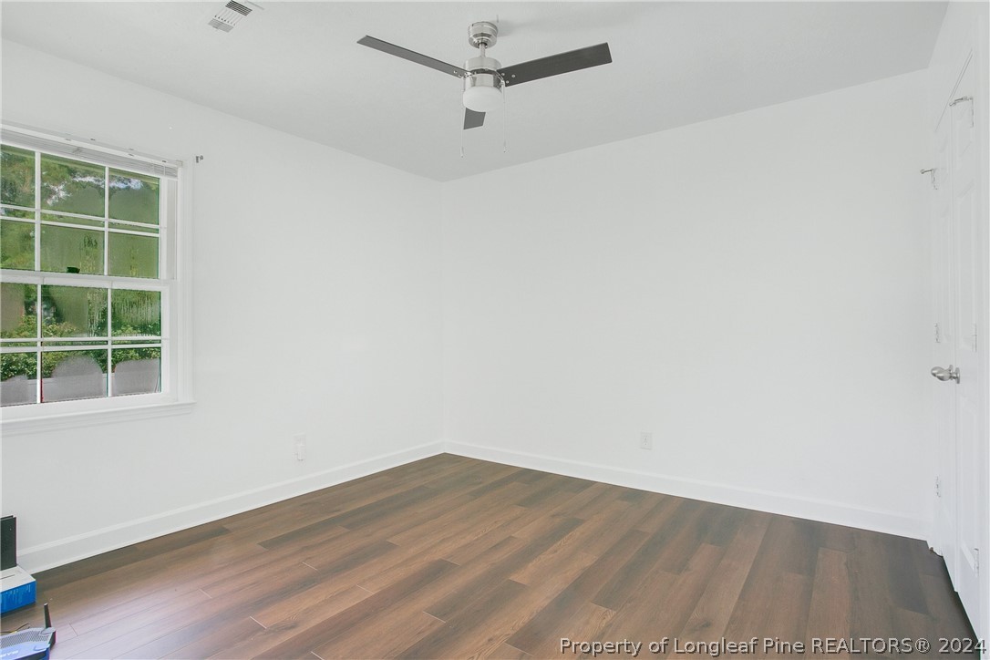 5809 Waldwick Road Fayetteville, NC 28311 - Photo 16 of 33 an empty room with a window and wooden floor
