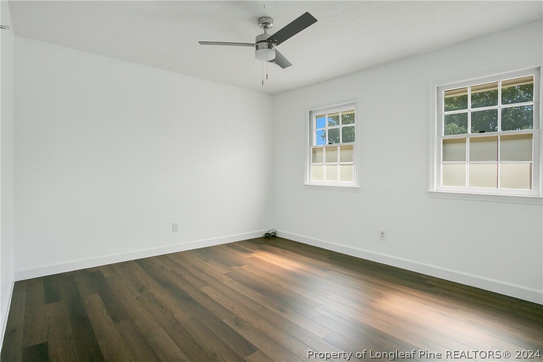 5809 Waldwick Road Fayetteville, NC 28311 - Photo 17 of 33 an empty room with wooden floor and windows