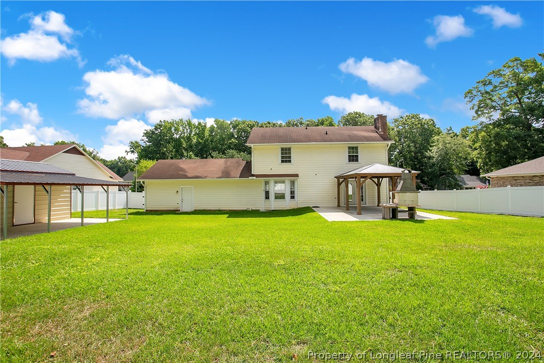5809 Waldwick Road Fayetteville, NC 28311 - Photo 24 of 33 a view of a house with a garden and a yard