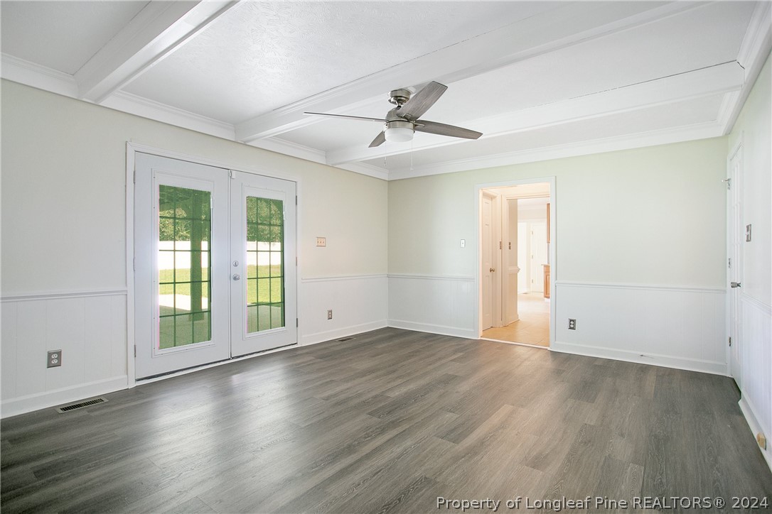 5809 Waldwick Road Fayetteville, NC 28311 - Photo 7 of 33 an empty room with wooden floor ceiling fan and windows