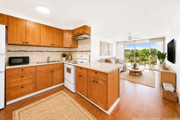a kitchen with sink cabinets and living room view