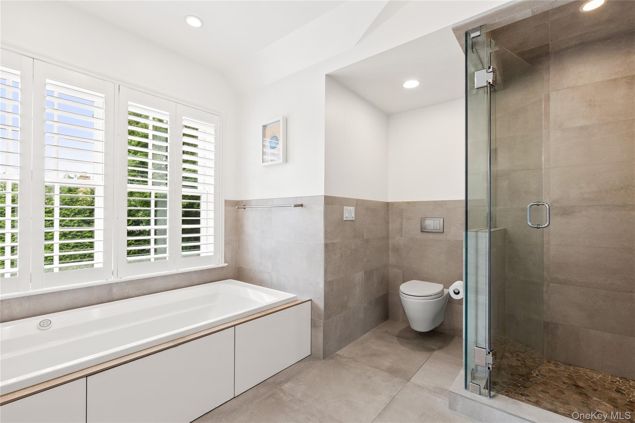 394 Park Avenue Rye, NY 10580 - Photo 19 of 36 Kohler bath tub, toto toilet, large glass shower, picture window with plantation shutters