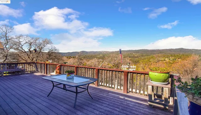 a view of a city from a roof deck with furniture