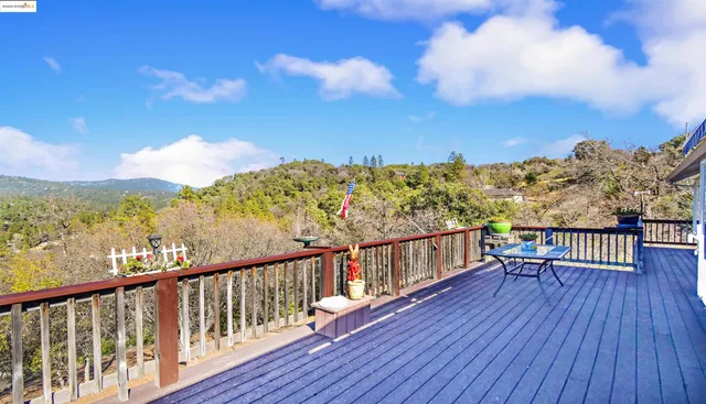 a view of balcony with wooden floor & fence