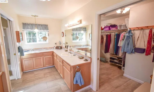 a bathroom with a tub sink and mirror