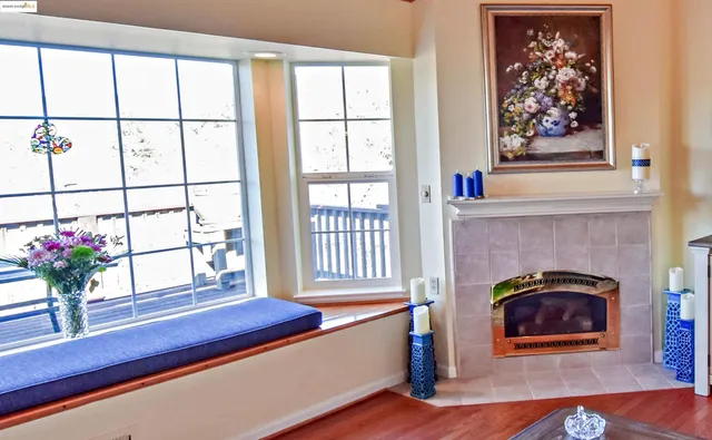 a living room with furniture a ceiling fan a flat screen tv and a window