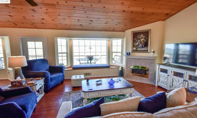 a view of a livingroom with workspace and a window