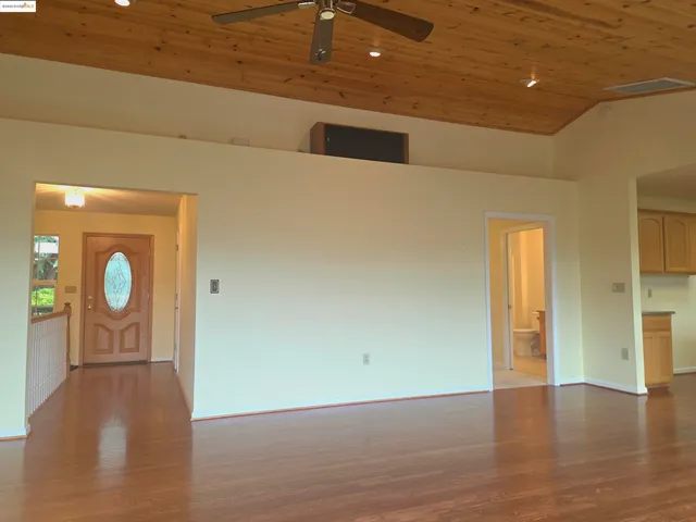 a view of hallway with wooden floor