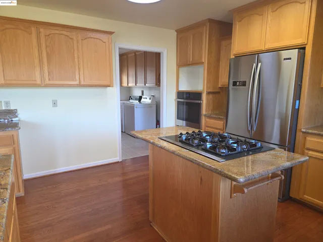 a balcony with wooden floor table and chairs