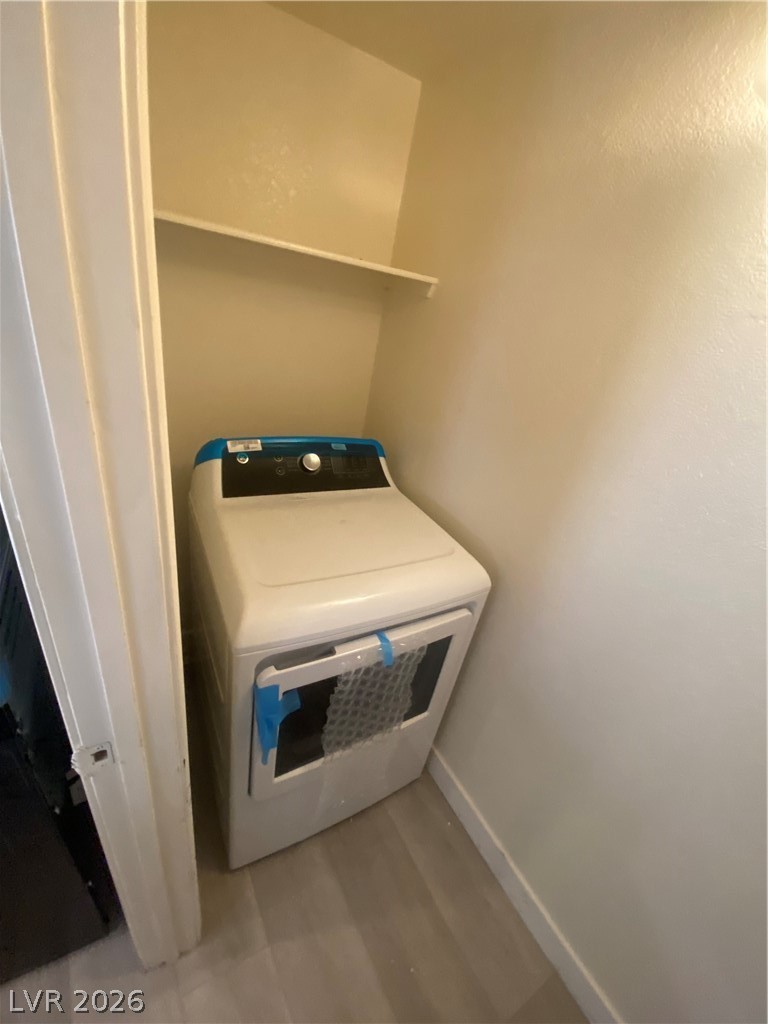 7570 West Flamingo Road, Unit 125 Las Vegas, NV 89147 - Photo 8 of 29 Laundry room featuring washer / dryer and light wood-type flooring