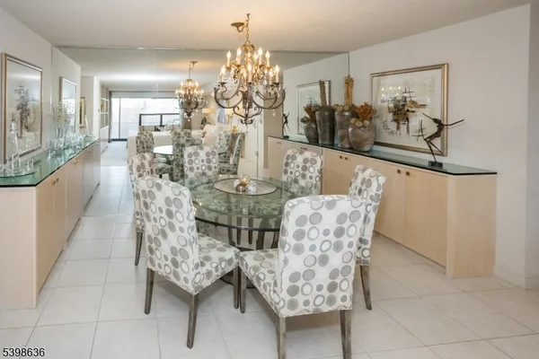 a view of a dining room with furniture and chandelier