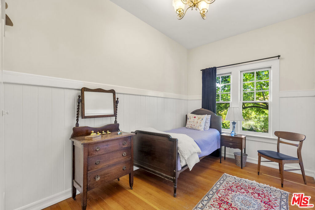 15454 South Mountain Road Santa Paula, CA 93060 - Photo 32 of 65 a bedroom with a bed and a chandelier