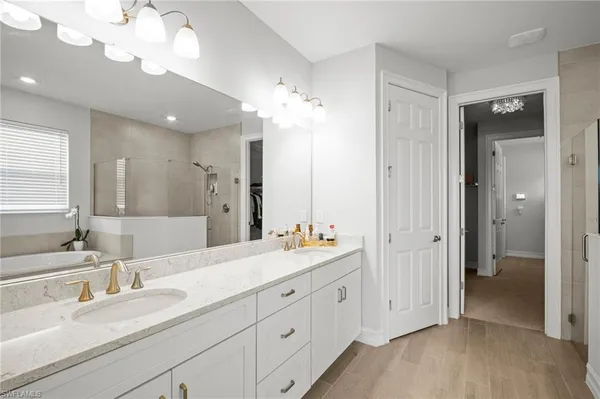 a en suite bathroom with double sink a large mirror and a shower