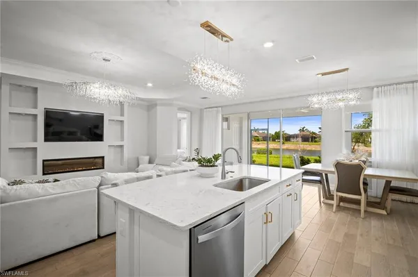 a large white kitchen with a large window