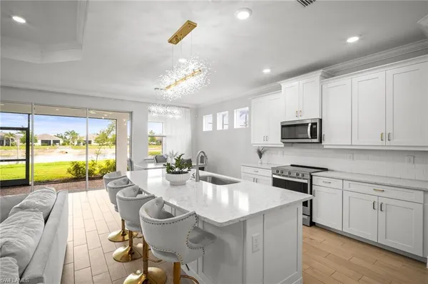a kitchen with stainless steel appliances kitchen island granite countertop a sink and cabinets