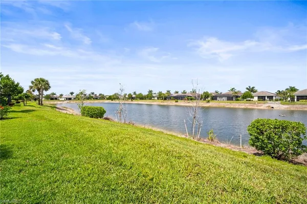 a view of a lake with houses in the back