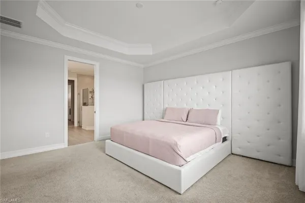 a bedroom with a bed and a night stand