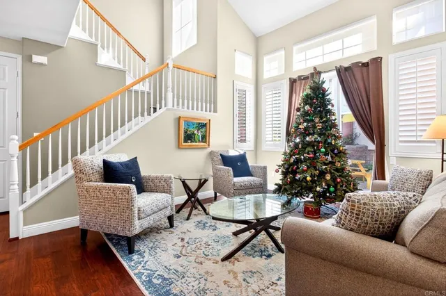 a kitchen with granite countertop wooden floors stainless steel appliances and a window