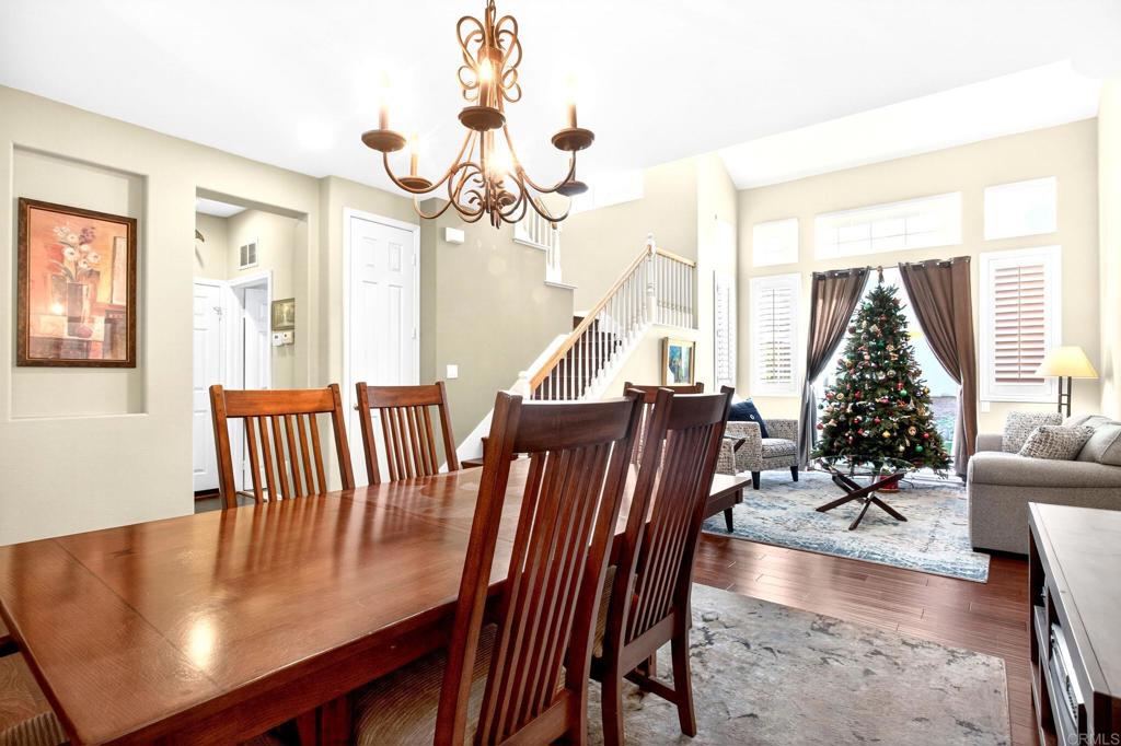 5531 Foxtail Loop Carlsbad, CA 92010 - Photo 14 of 62 a view of a dining room with furniture wooden floor and chandelier