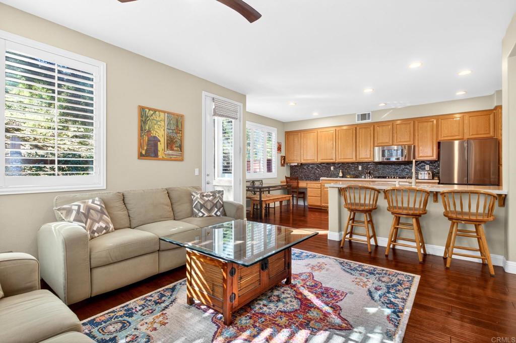 5531 Foxtail Loop Carlsbad, CA 92010 - Photo 23 of 62 a living room with furniture kitchen and a table