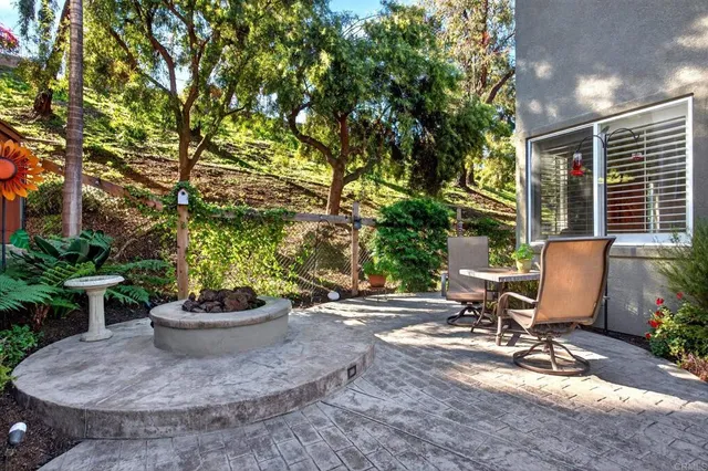 a view of staircase with lots of frames on wall and a window