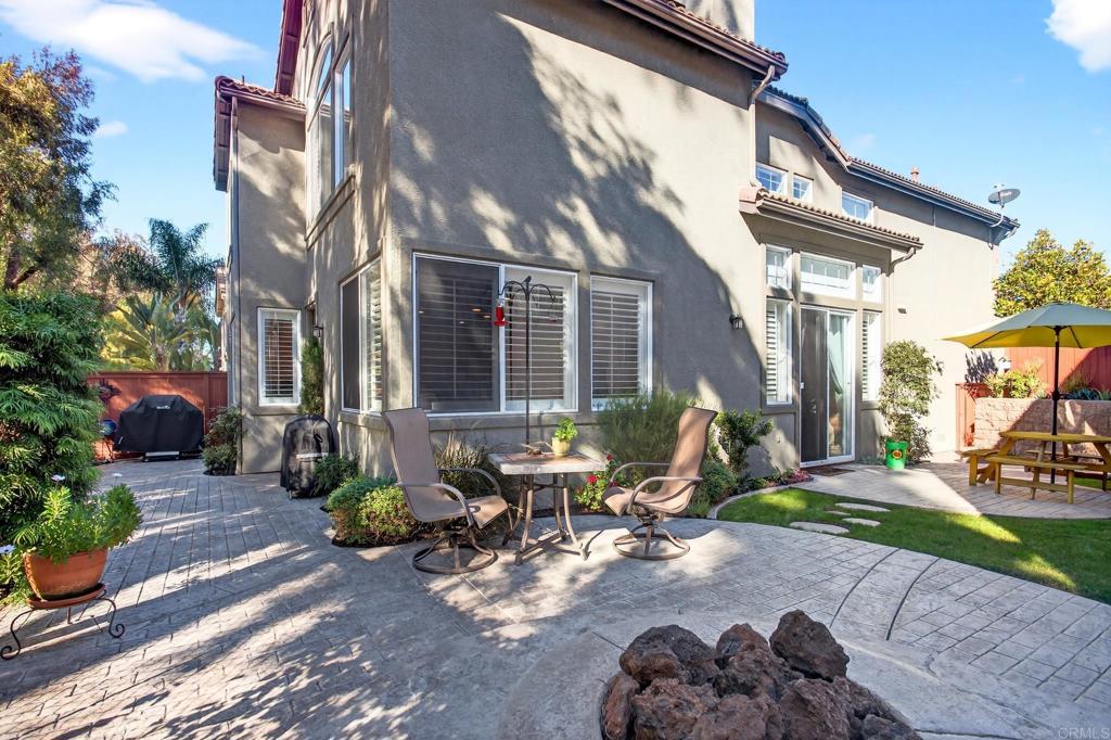 5531 Foxtail Loop Carlsbad, CA 92010 - Photo 38 of 62 a view of a patio with table and chairs and potted plants