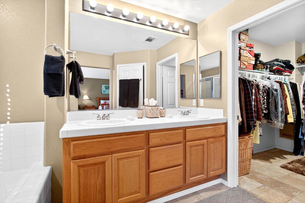 5531 Foxtail Loop Carlsbad, CA 92010 - Photo 48 of 62 a bathroom with a sink vanity and mirror