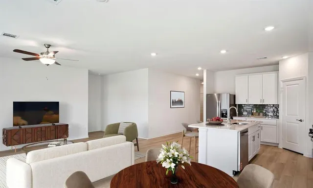 a view of kitchen with stainless steel appliances granite countertop cabinets and wooden floor