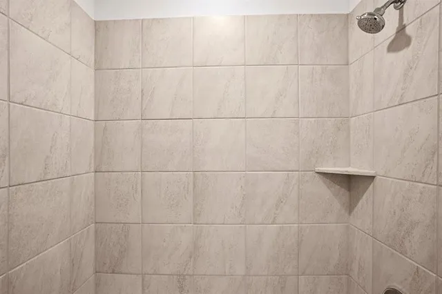 a bathroom with a close shower view and a shower curtain