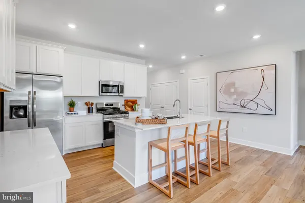 a view of kitchen with cabinets and wooden floor