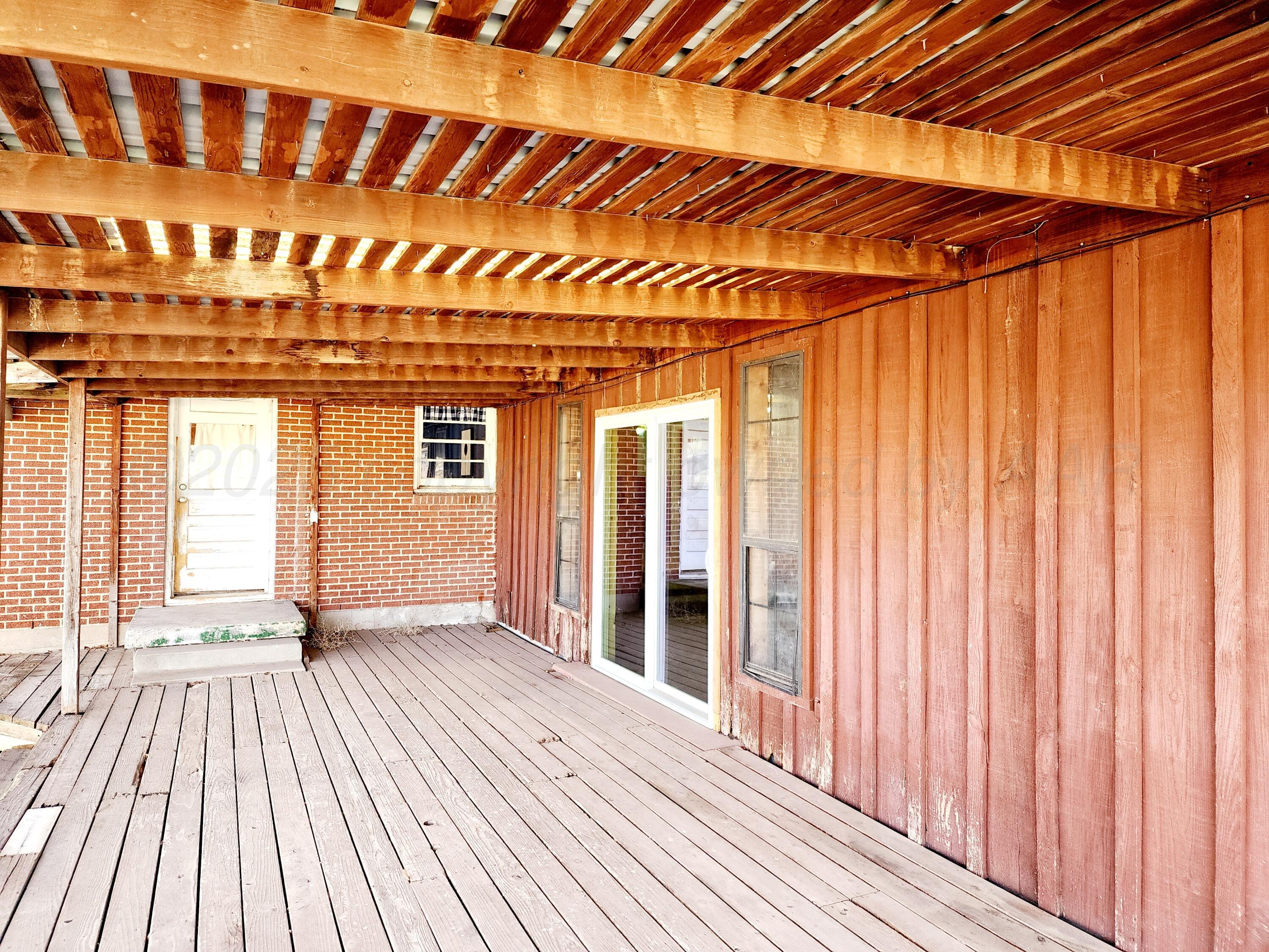 3320 Lynette Drive Amarillo, TX 79109 - Photo 17 of 19 a view of front door with deck and wooden floor