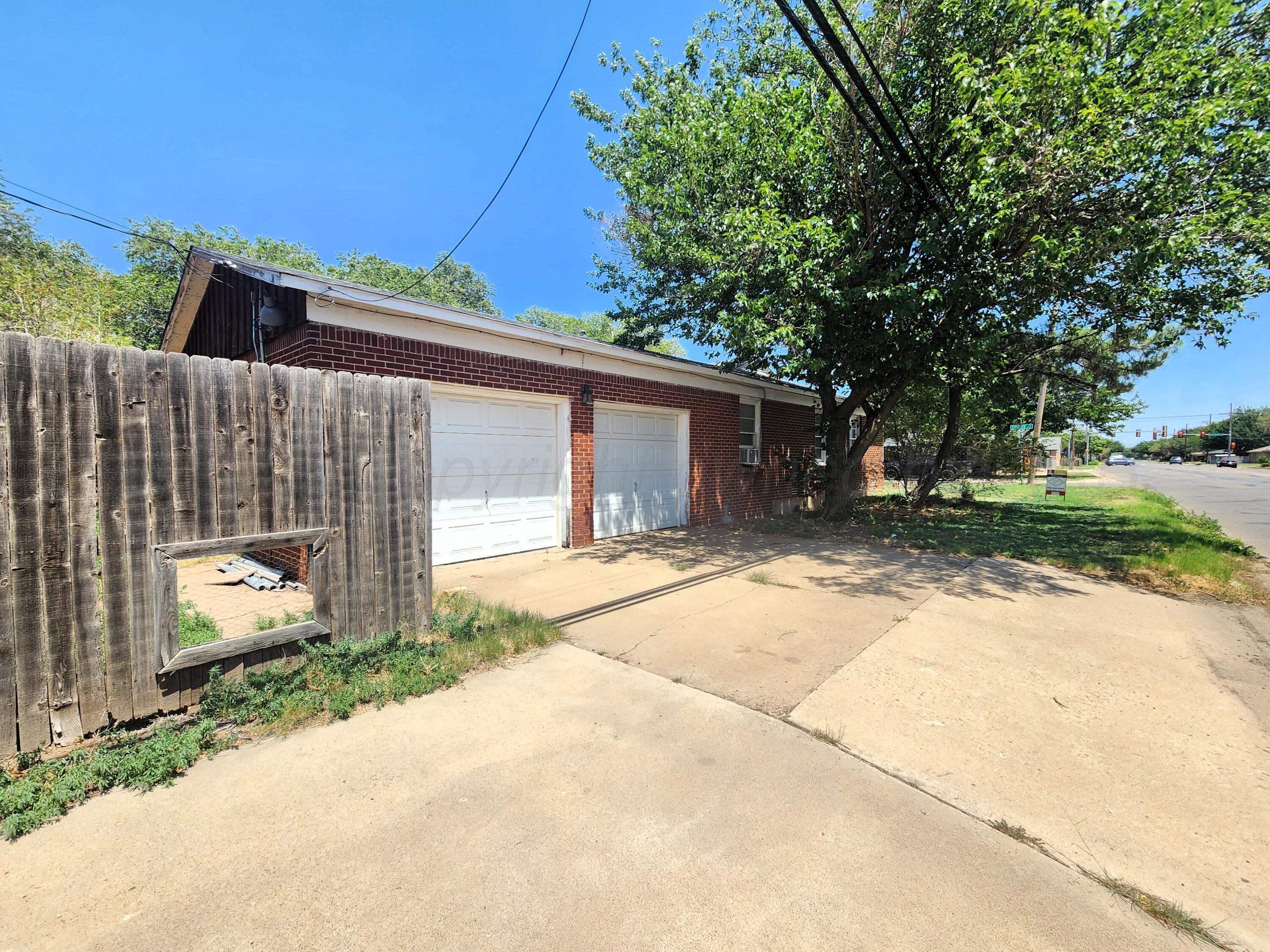 3320 Lynette Drive Amarillo, TX 79109 - Photo 19 of 19 a front view of a house with a yard and garage
