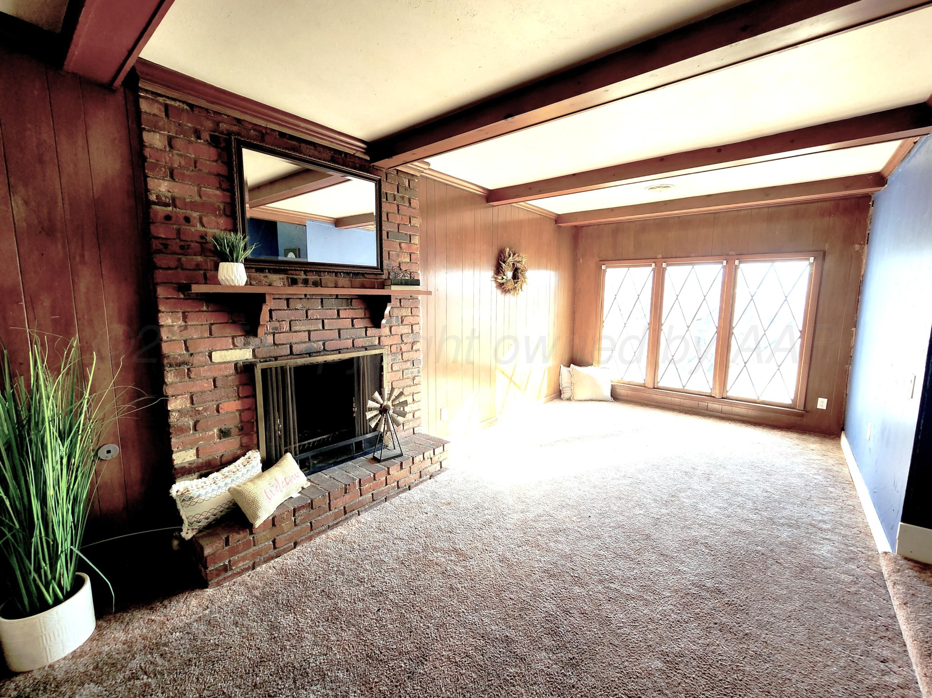 3320 Lynette Drive Amarillo, TX 79109 - Photo 2 of 19 a living room with furniture and a fireplace