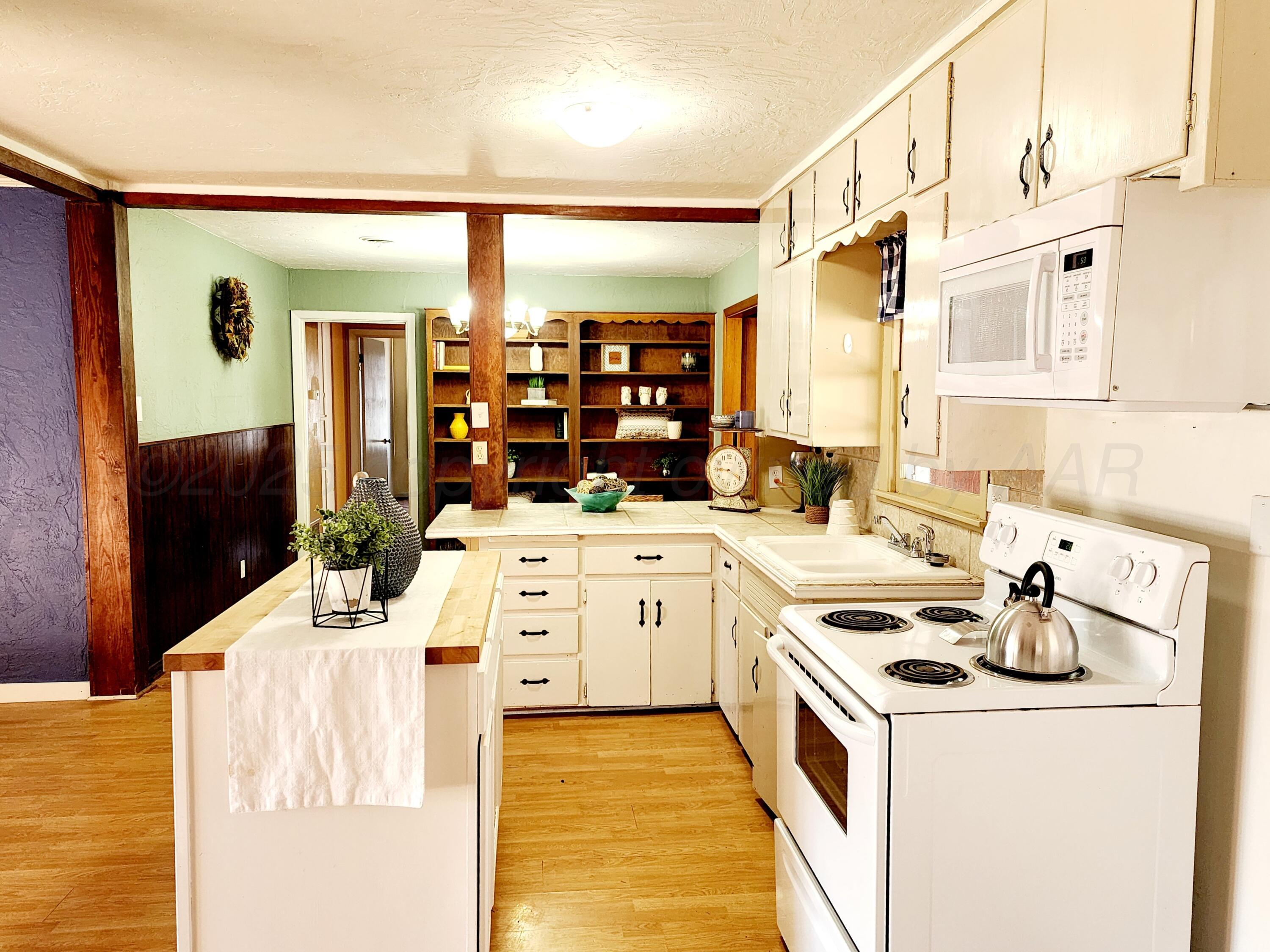 3320 Lynette Drive Amarillo, TX 79109 - Photo 5 of 19 a kitchen with a stove and a white refrigerator