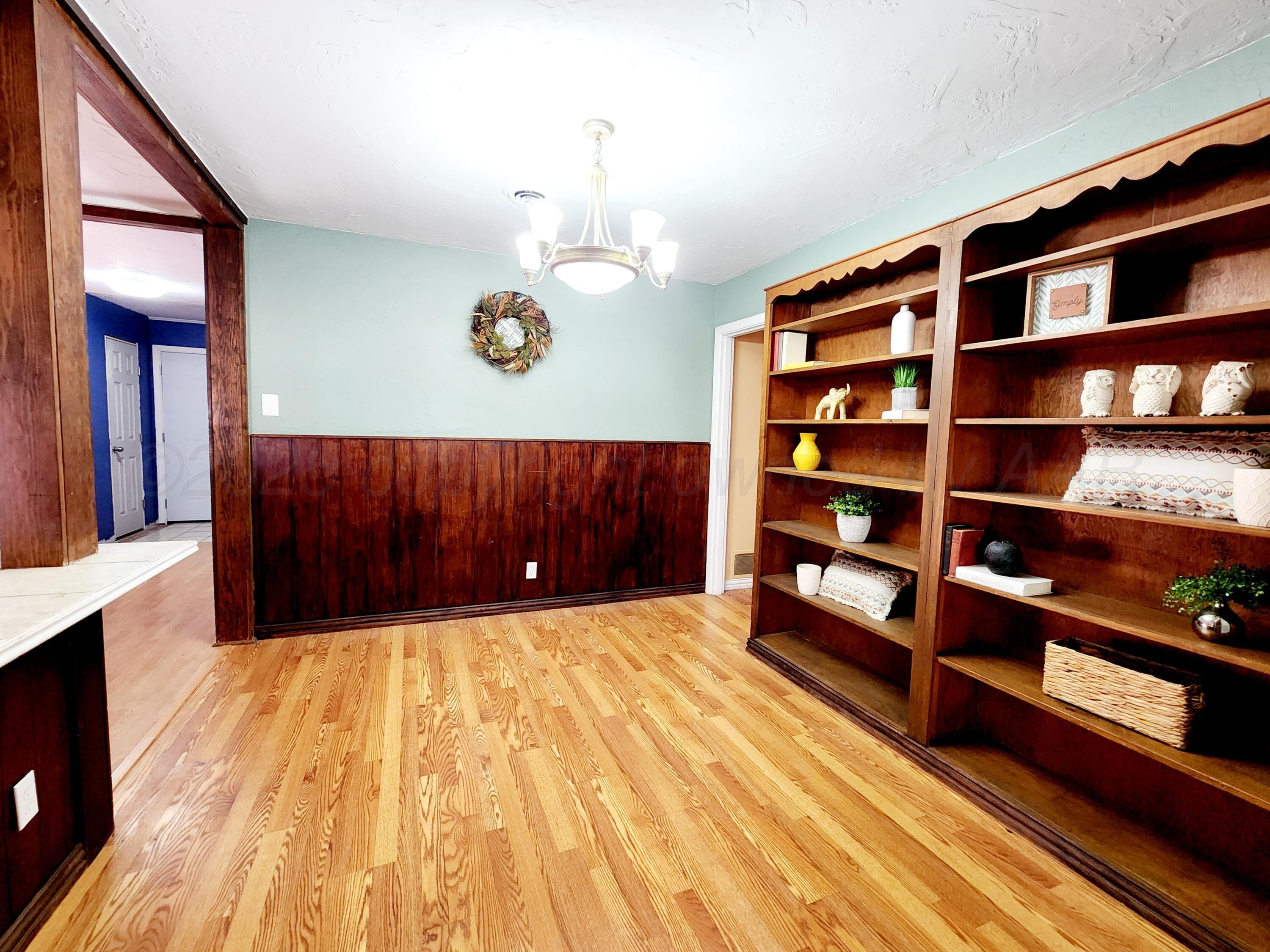 3320 Lynette Drive Amarillo, TX 79109 - Photo 6 of 19 a bedroom with a bed and a book shelf