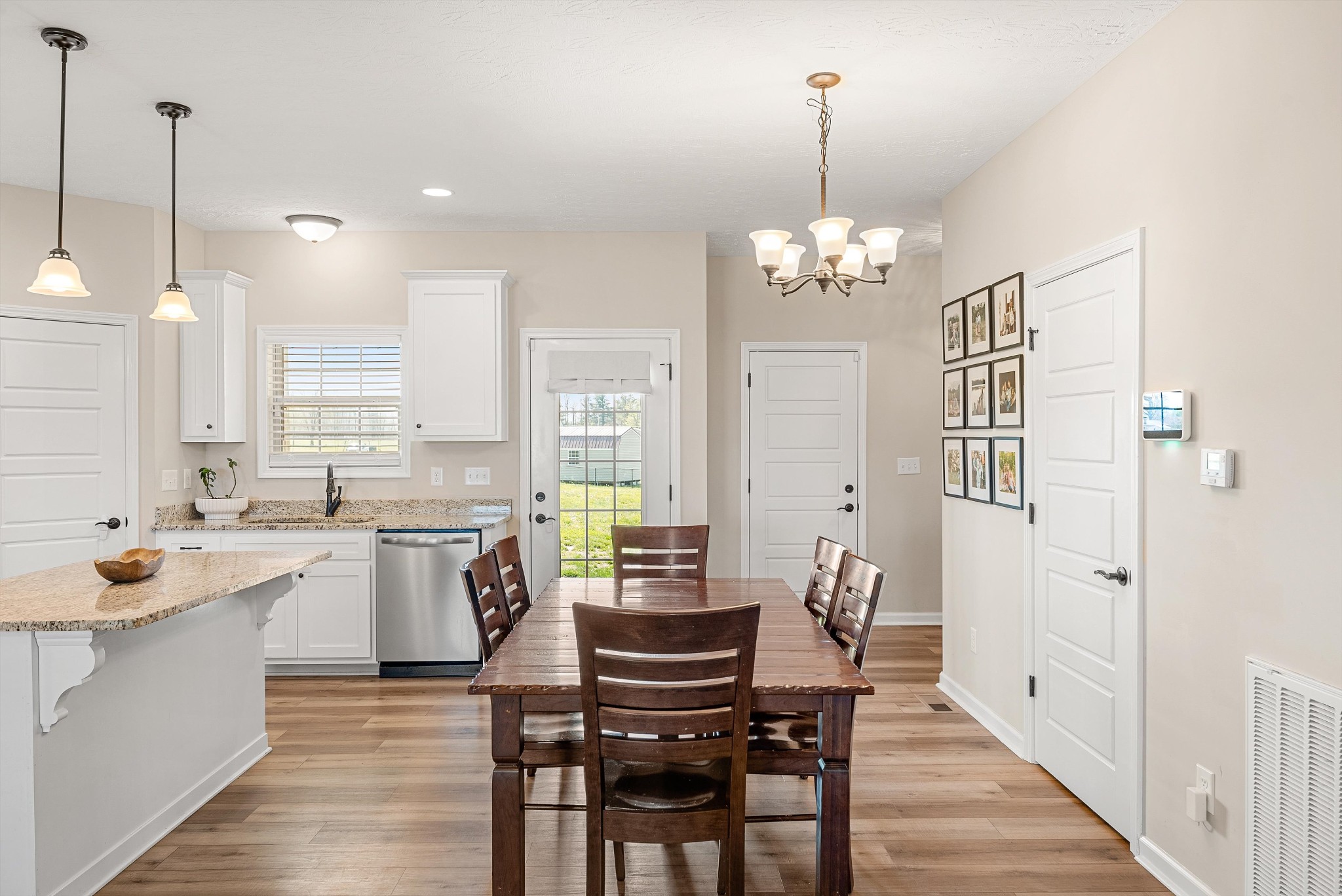 57 Cheney Lane Lafayette, TN 37083 - Photo 11 of 35 a large kitchen with kitchen island a dining table chairs and a wooden floor