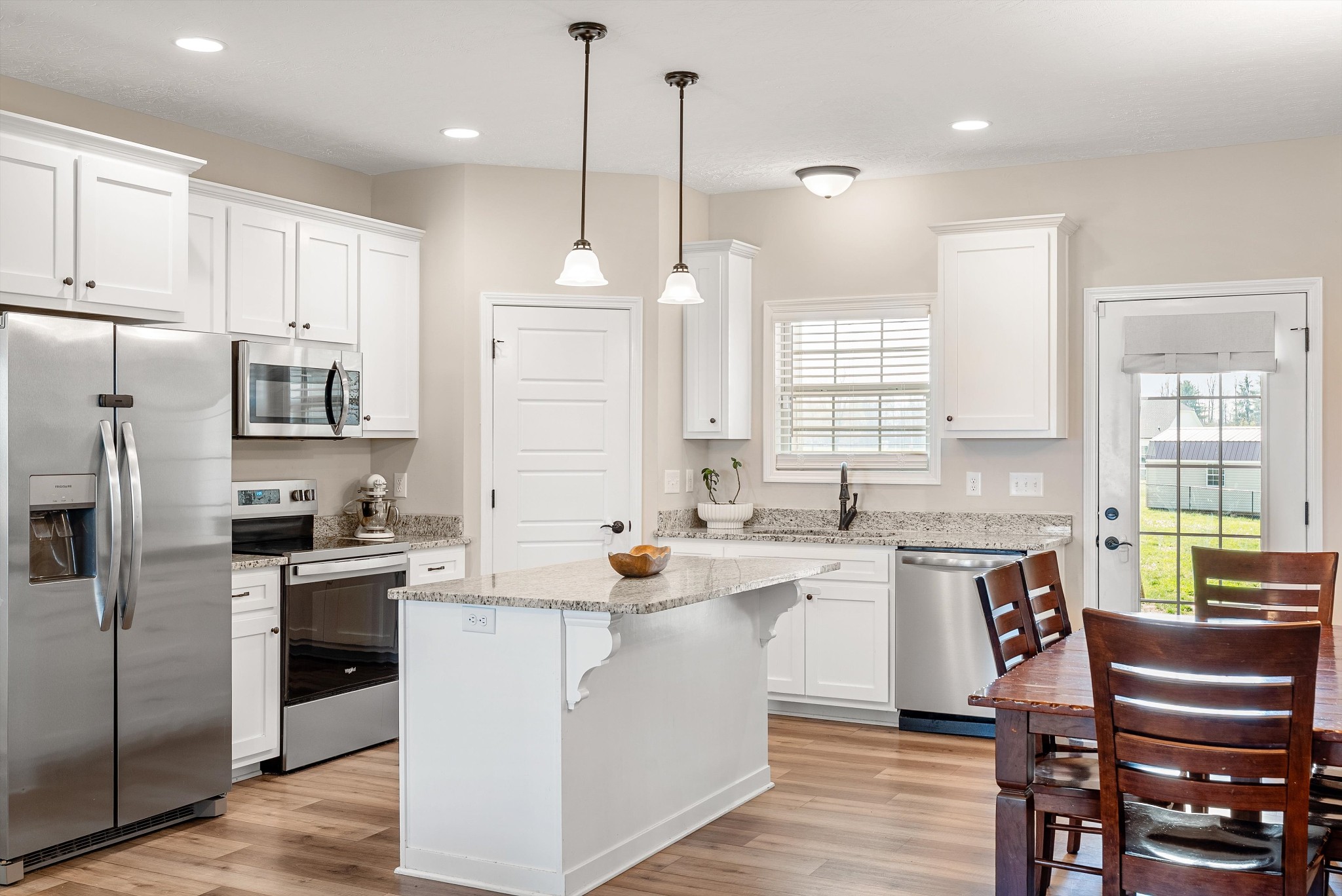 57 Cheney Lane Lafayette, TN 37083 - Photo 12 of 35 a kitchen with a sink a counter top space stainless steel appliances and cabinets