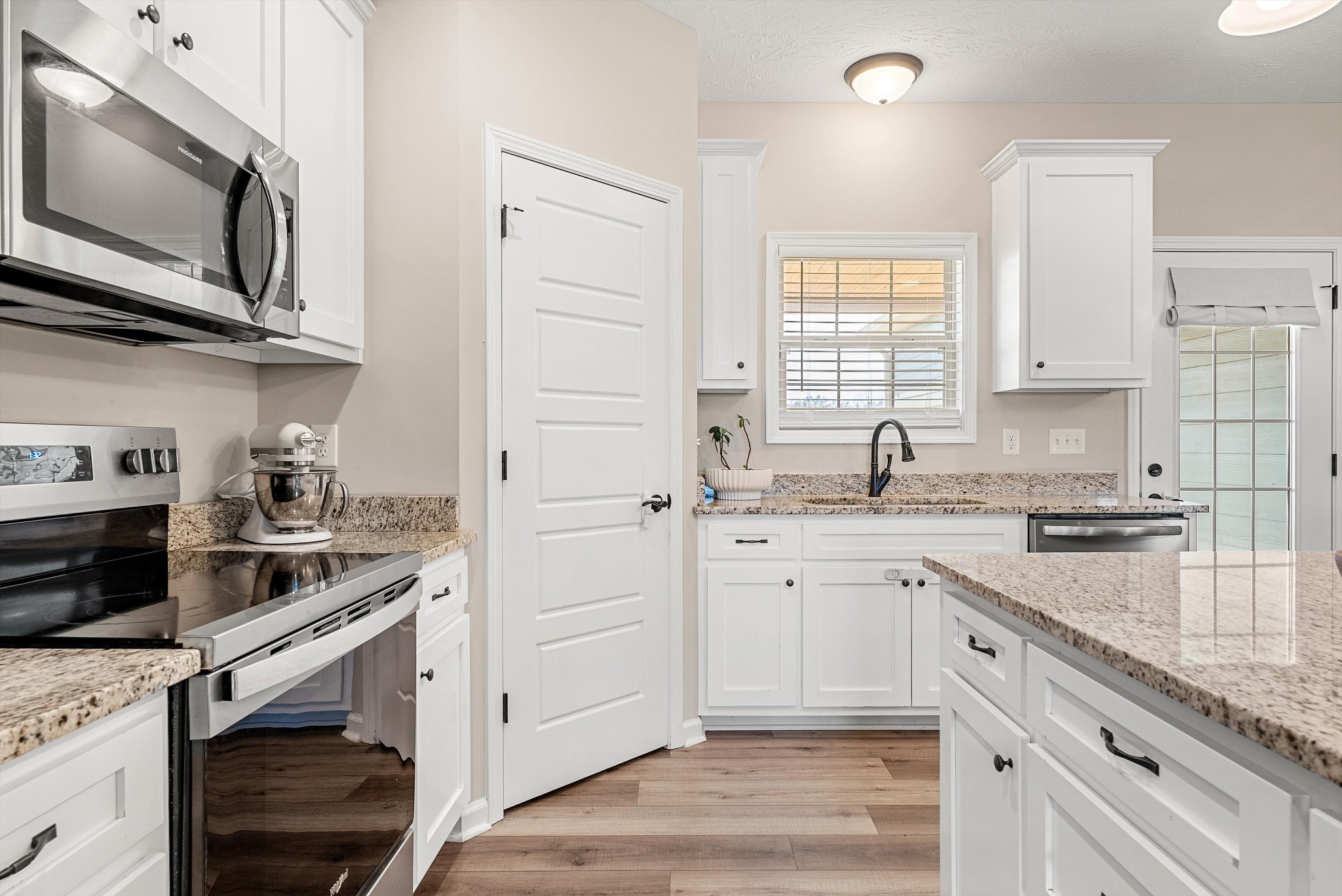 57 Cheney Lane Lafayette, TN 37083 - Photo 8 of 35 a kitchen with stainless steel appliances granite countertop a sink stove and microwave