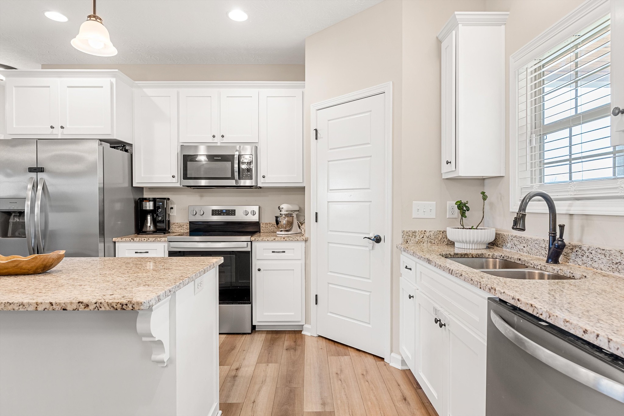 57 Cheney Lane Lafayette, TN 37083 - Photo 9 of 35 a kitchen with a sink white cabinets and stainless steel appliances