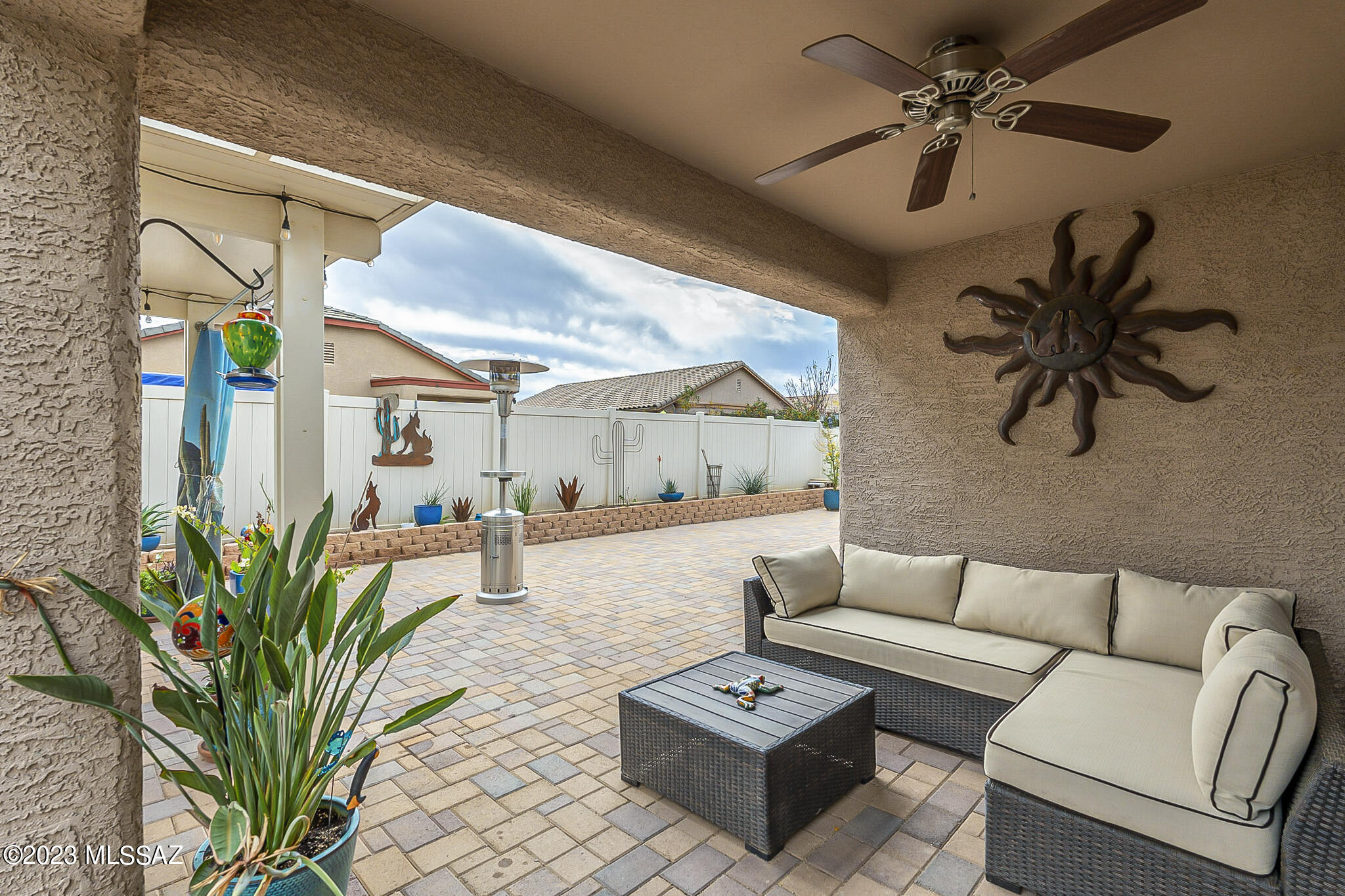 21311 East Founders Road Red Rock, AZ 85145 - Photo 14 of 20 a living room with furniture a chandelier and a potted plant