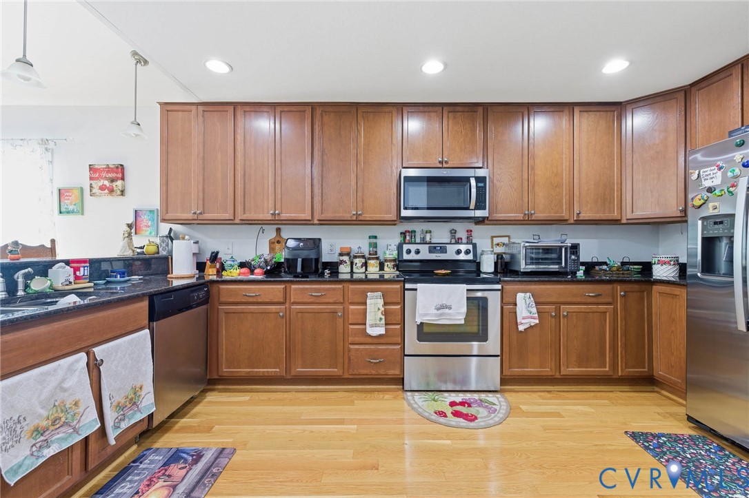 15900 Nobles Road Disputanta, VA 23842 - Photo 11 of 36 Kitchen featuring brown cabinetry, stainless steel