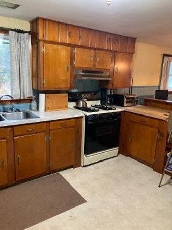 14 Lawrence Road Haverhill, MA 01835 - Photo 6 of 14 a kitchen with stainless steel appliances granite countertop a stove a sink and a microwave