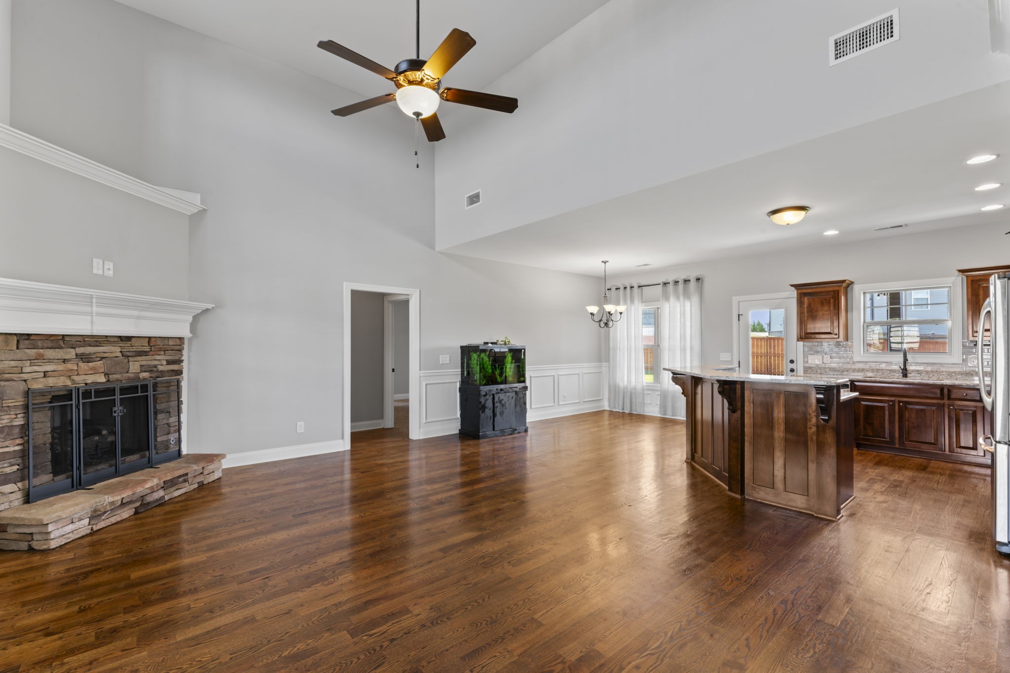 2314 Tranquility Trail Smyrna, TN 37167 - Photo 4 of 35 a view of a livingroom with furniture a ceiling fan wooden floor and a kitchen