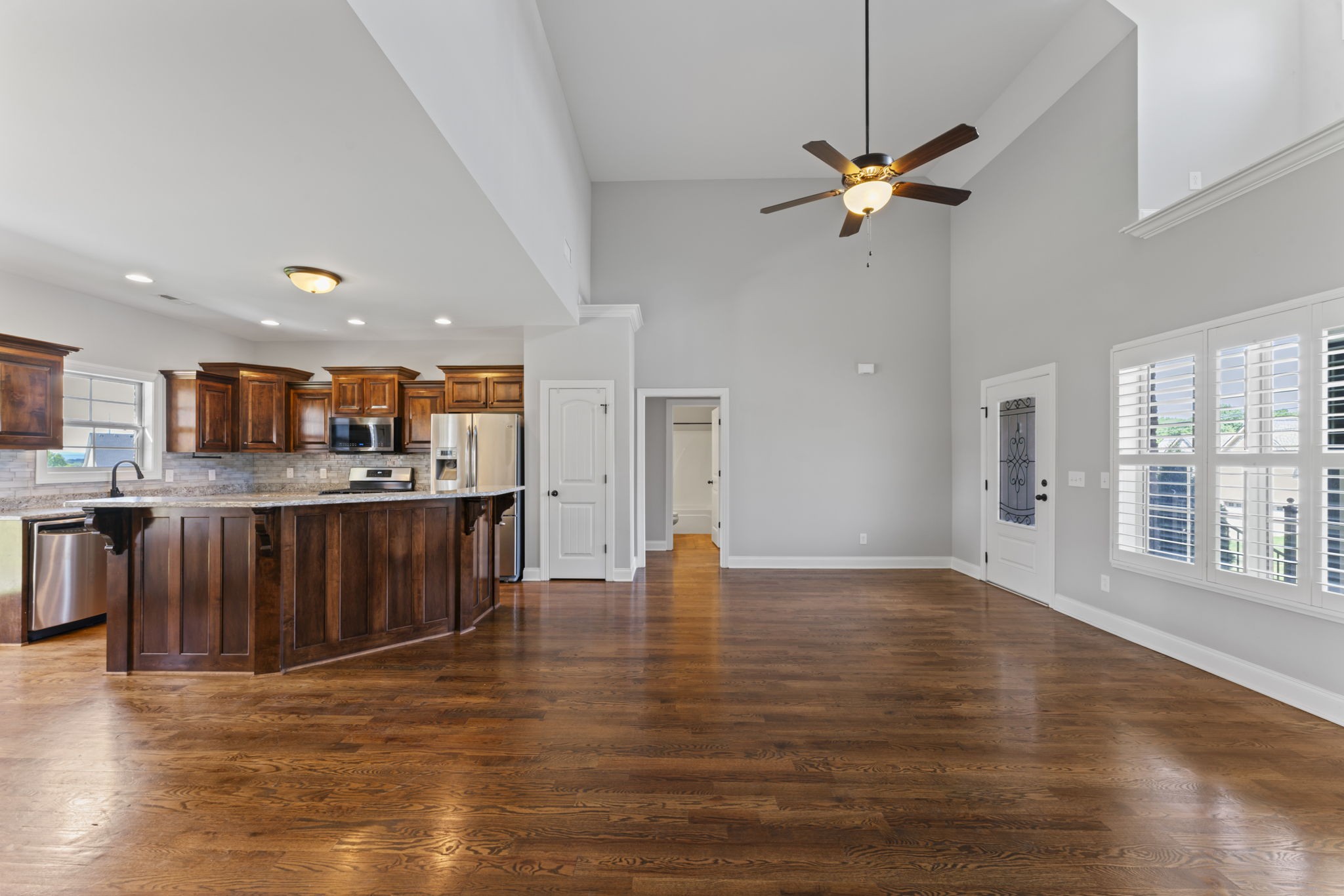2314 Tranquility Trail Smyrna, TN 37167 - Photo 6 of 35 a view of a kitchen with kitchen island a sink wooden floor and a counter top space
