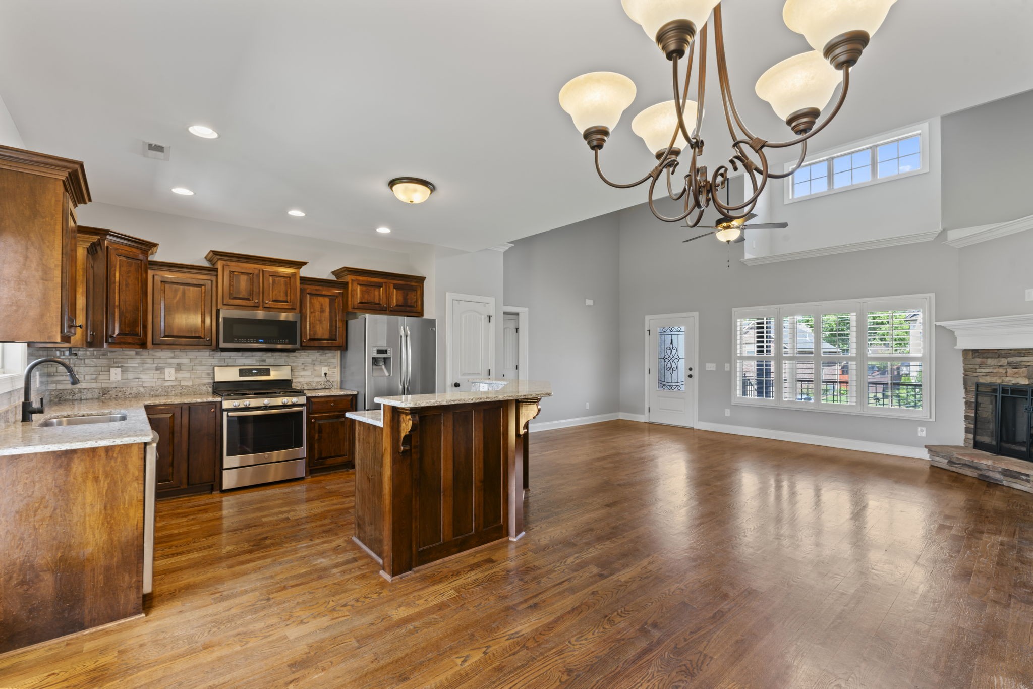 2314 Tranquility Trail Smyrna, TN 37167 - Photo 8 of 35 a kitchen with stainless steel appliances granite countertop a stove top oven a sink dishwasher a dining table and chairs with wooden floor