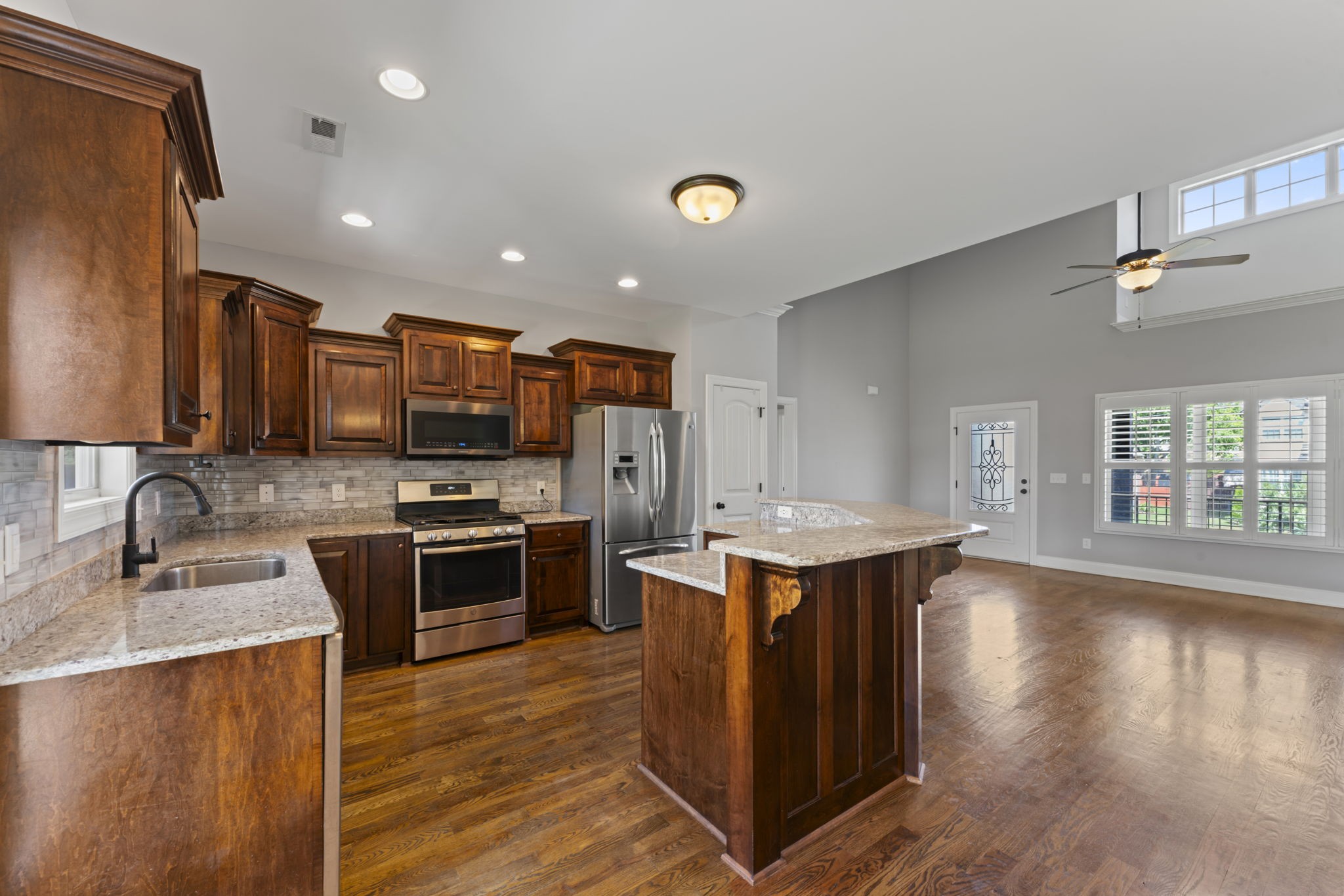 2314 Tranquility Trail Smyrna, TN 37167 - Photo 10 of 35 a kitchen with stainless steel appliances a sink dishwasher stove and oven with wooden floor