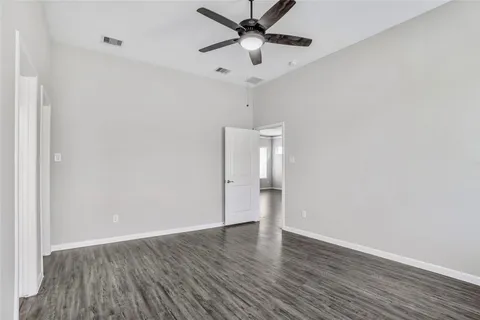 a bathroom with a granite countertop sink a toilet a mirror and bathtub