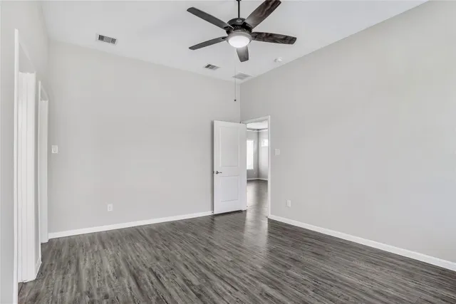 a bathroom with a granite countertop sink a toilet a mirror and bathtub
