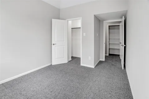 a view of a hallway with wooden shelves