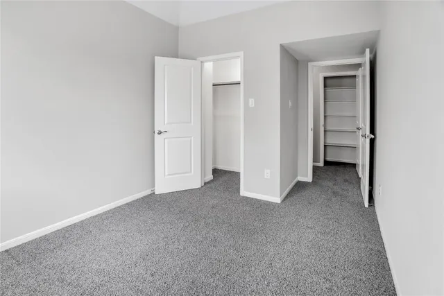 a view of a hallway with wooden shelves